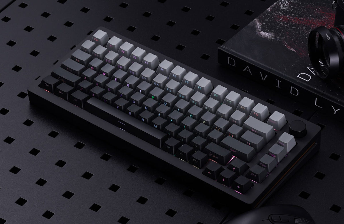MonsGeek M1W-SP HE fully assembled magnetic keyboard on a dark desktop setup with RGB lighting and camera gear